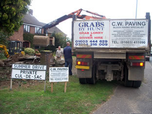 Kevin picking up unwanted rubble from a driveway refurbishment.